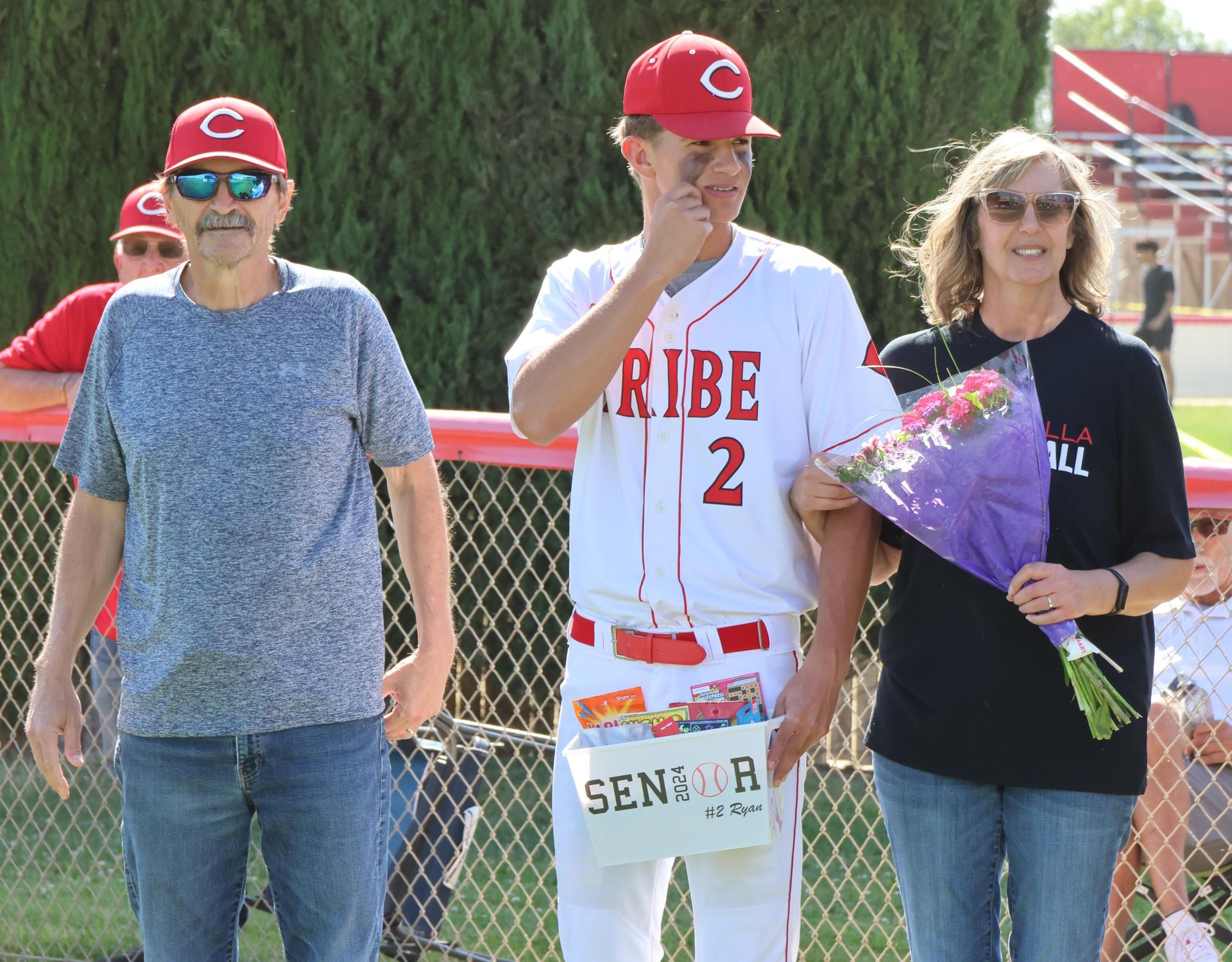 Seniors Posing With Teammates, Coaches, And Family