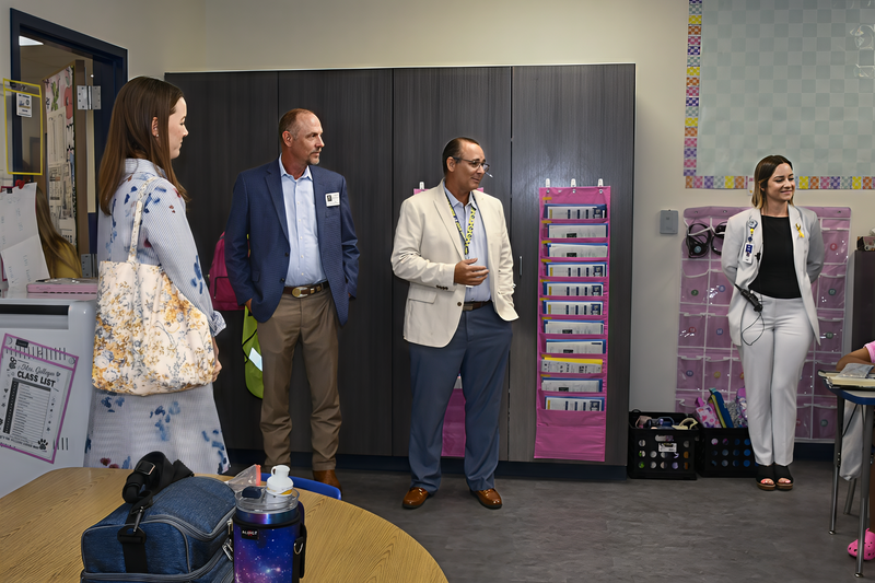 A group of adults observing a school classroom