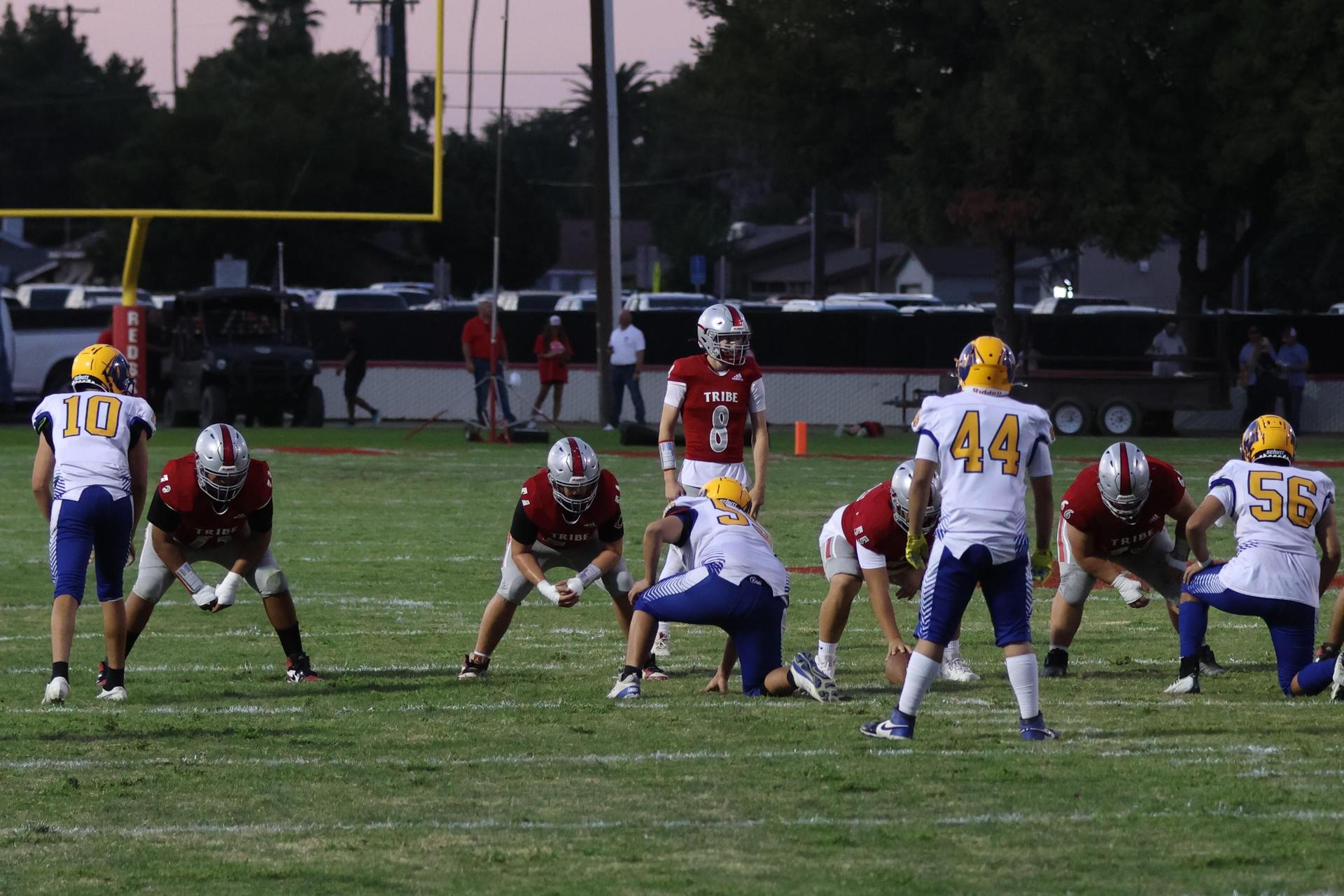 Varsity football players in action against Parlier 7