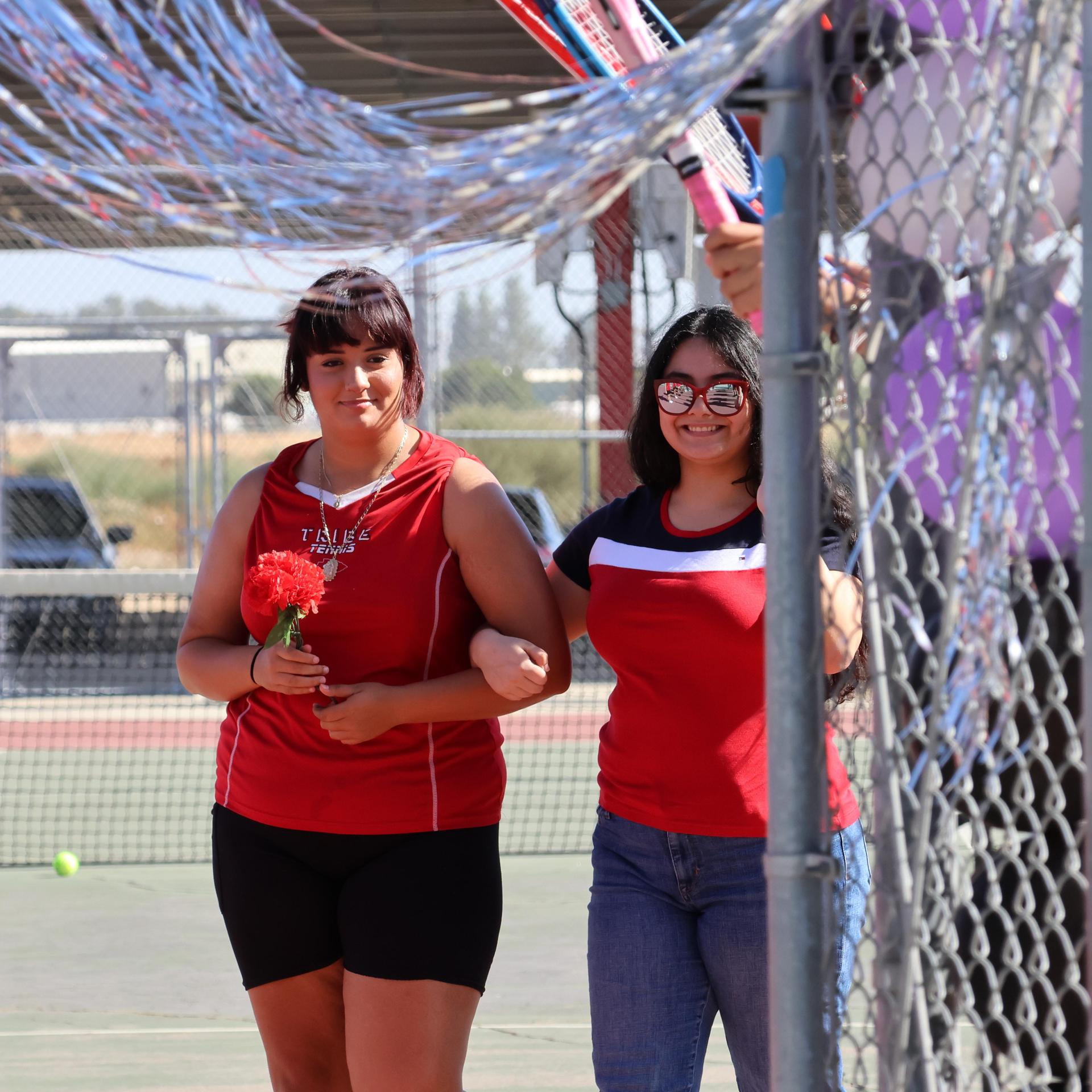 tennis players, family, and staff celebrating senior night