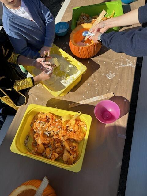 yellow bowl with mashed pumpkins with children's hands mixing and emptying a pumpkin.