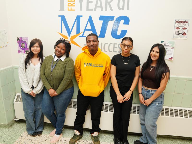 Five students standing in front of a mural advertising a free year at MATC