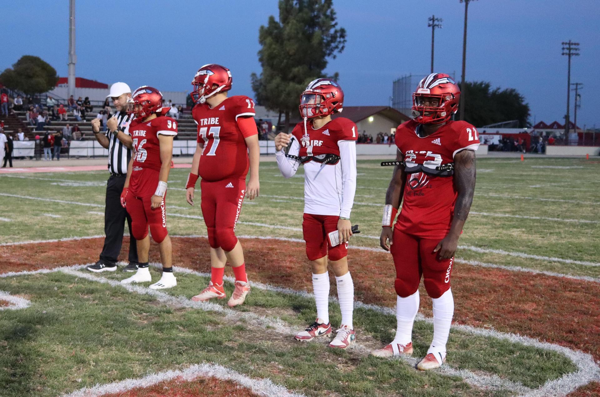 varsity football players in action against Riverdale