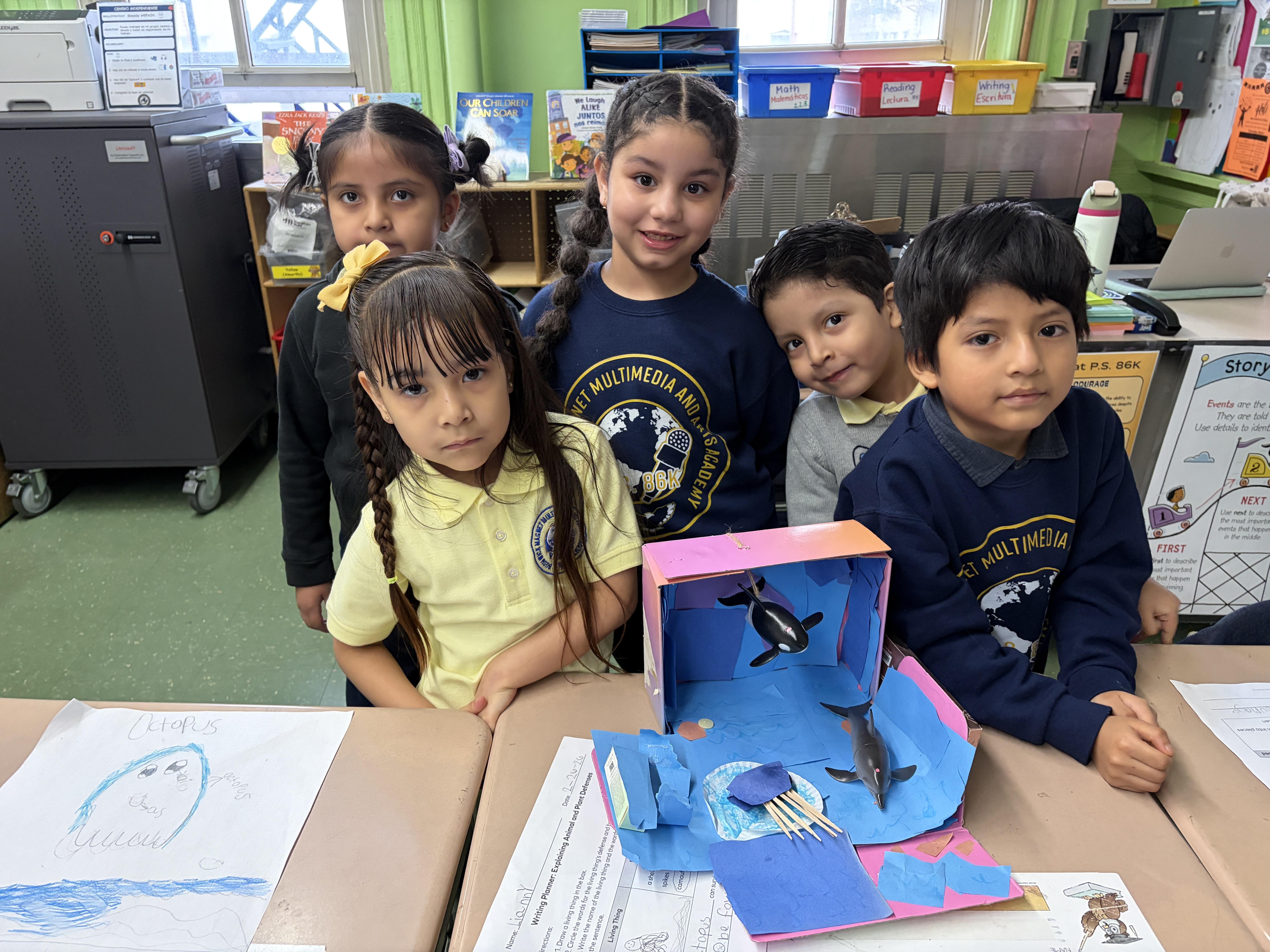 group of students around an animal diarama