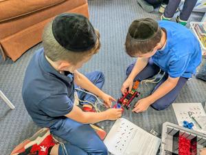two fourth grade students work together to build a robot
