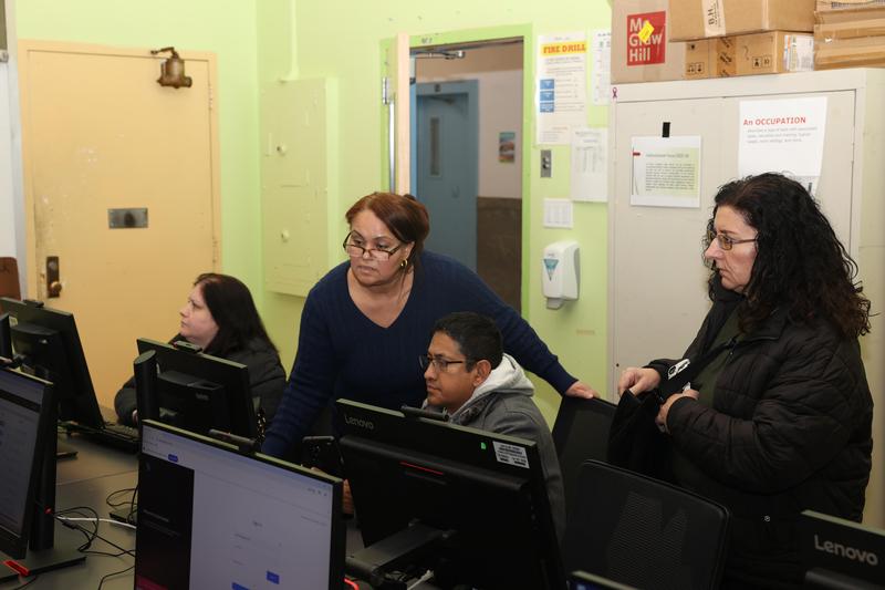 Parents sitting by computers during meeting
