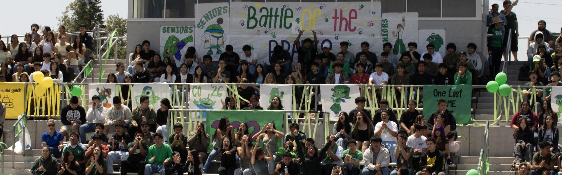 Crowd of students at a spirited school event with banners and decorations.
