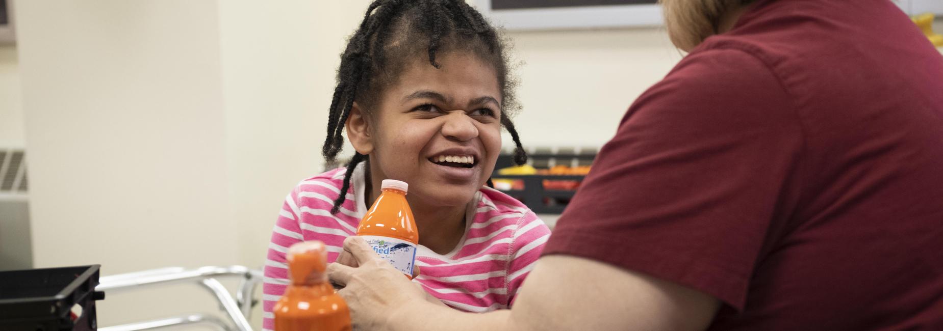 student laughing in art class