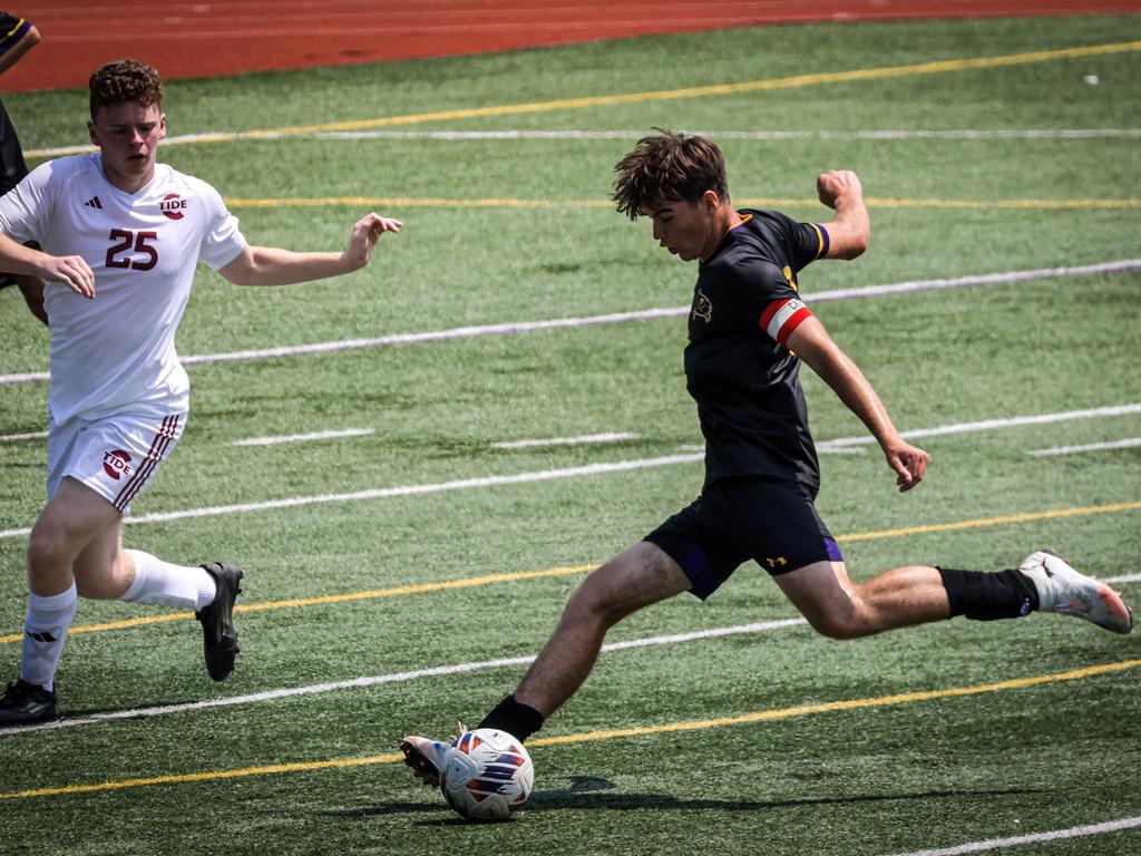A soccer player about to kick the ball.