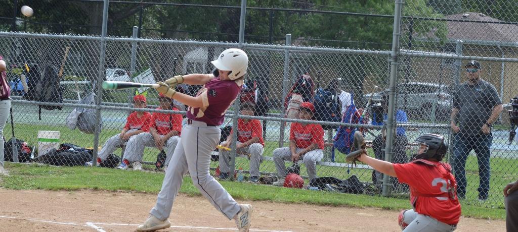 Baseball player hits the ball.