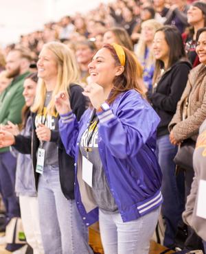 Enthusiastic crowd cheering at a sports event.