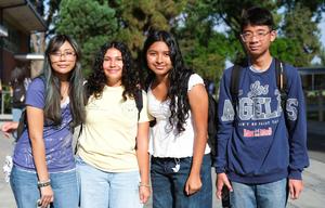 A group of four Whittier Union students stand in a line and smile as they pose for a photo during the first day of school on August 12.