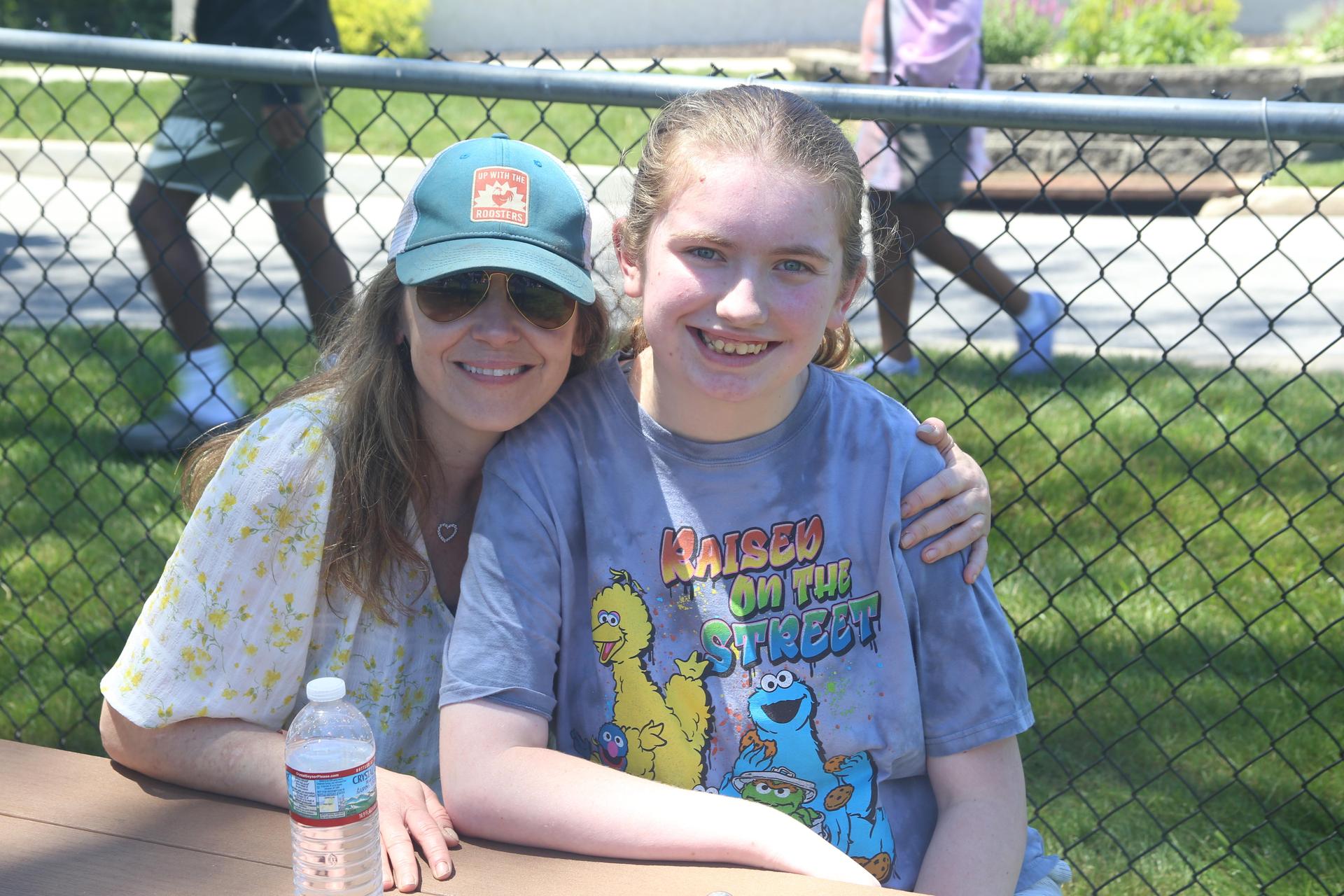 Mother and daughter smiling at camera.