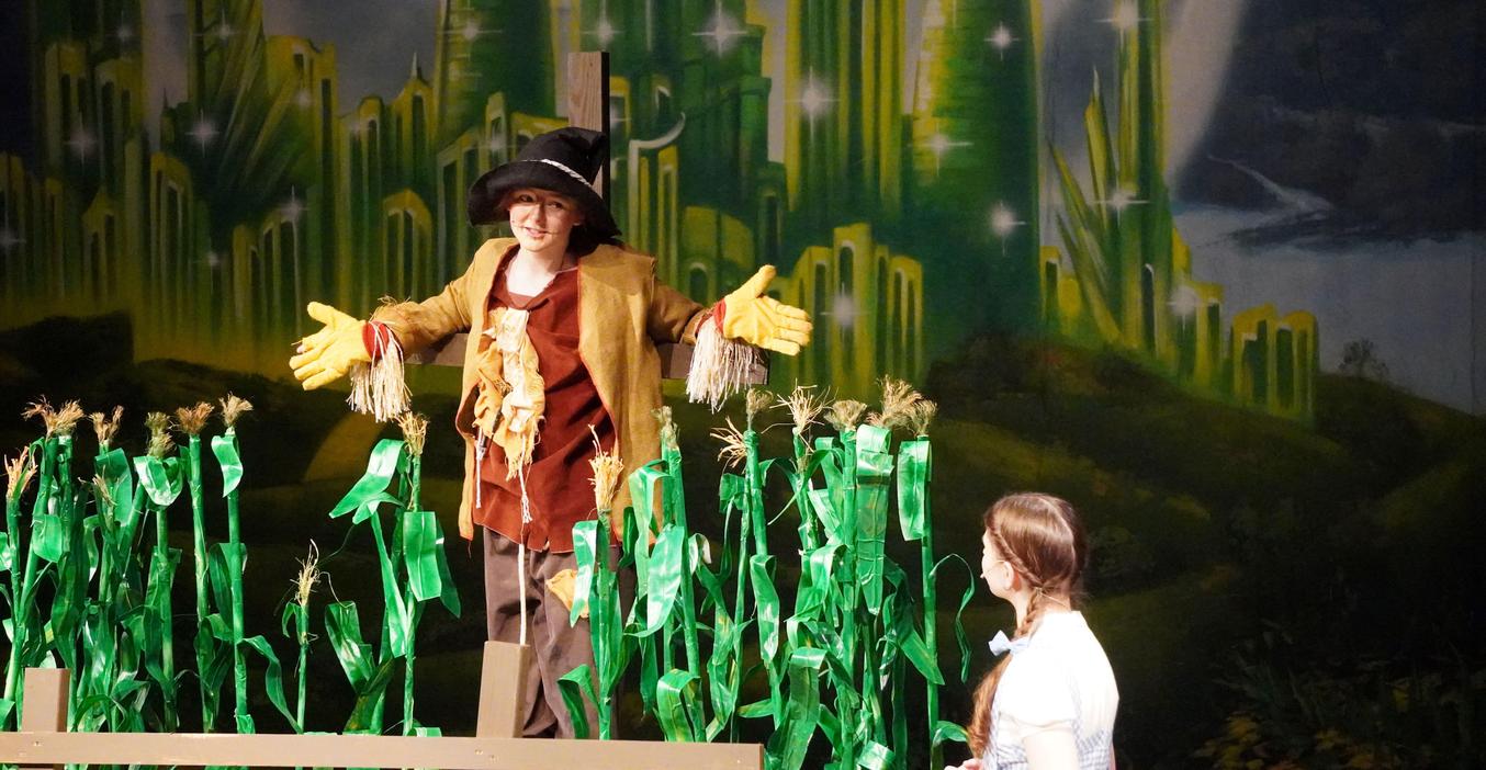 Dorothy meets the Scarecrow in a spring musical performance of "Wizard of Oz."