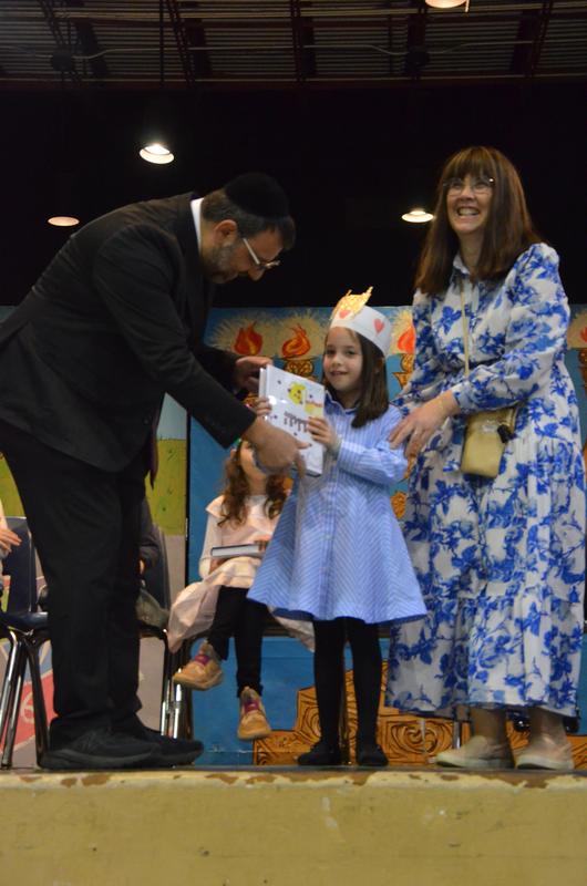 The girls receive their chumashim.