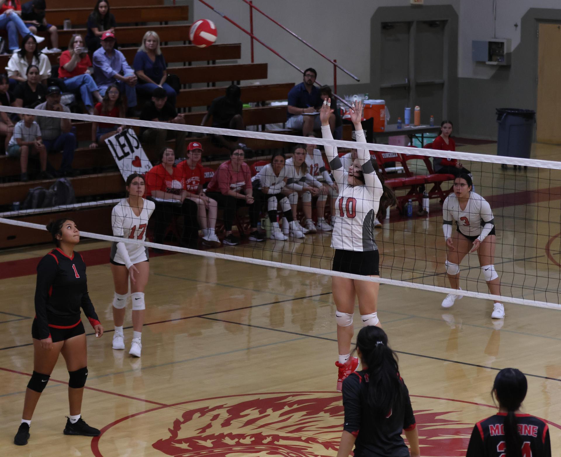junior varsity girls playing volleyball 133