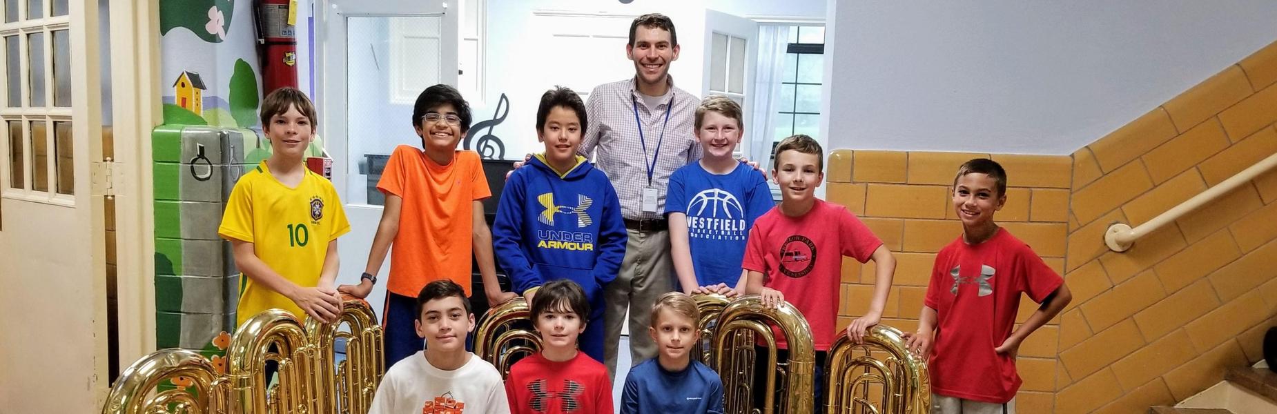 Photo of Franklin School tuba players with their tuba playing music director.