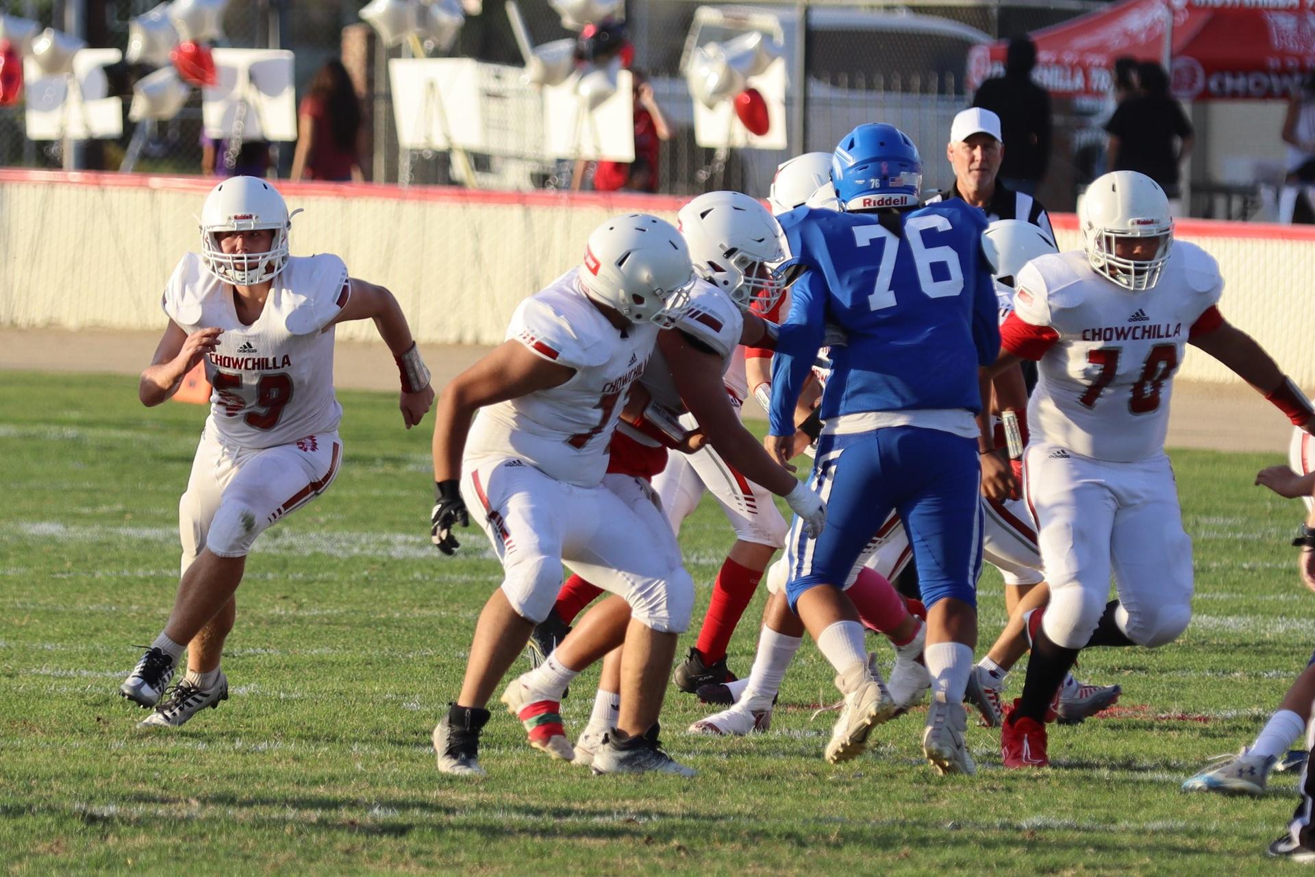 Junior Varsity football players in action against Caruthers