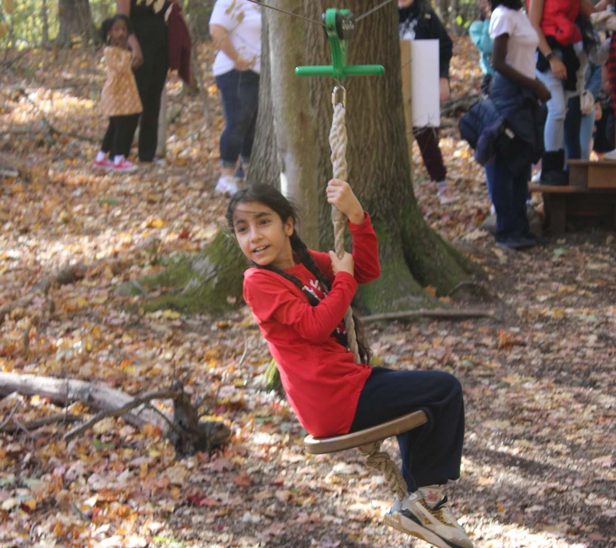 A Concept Schools student swings during a program field trip.