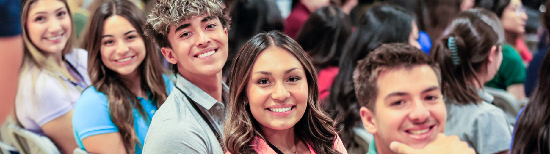 Group of happy students smiling at an event