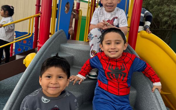 Three boys on the slide.