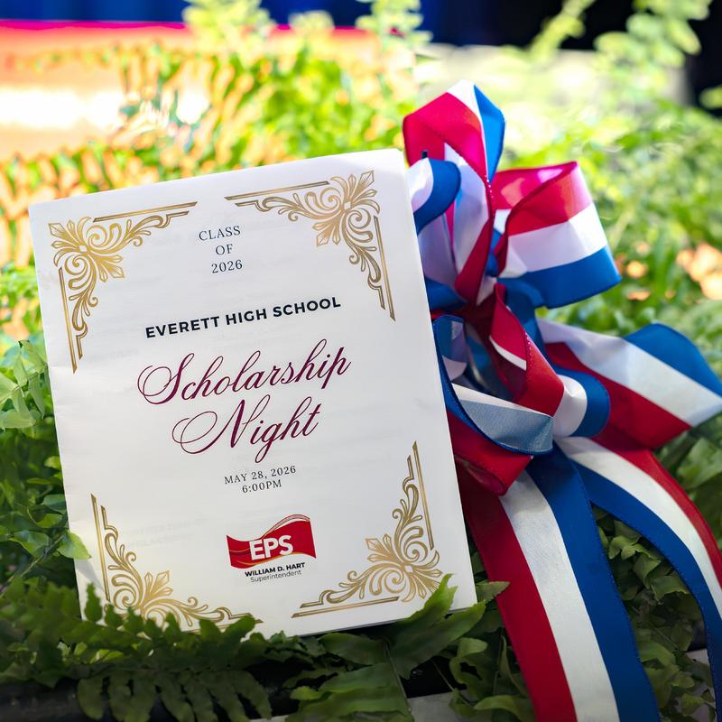 Scholarship Night program with decorative ribbon and greenery.