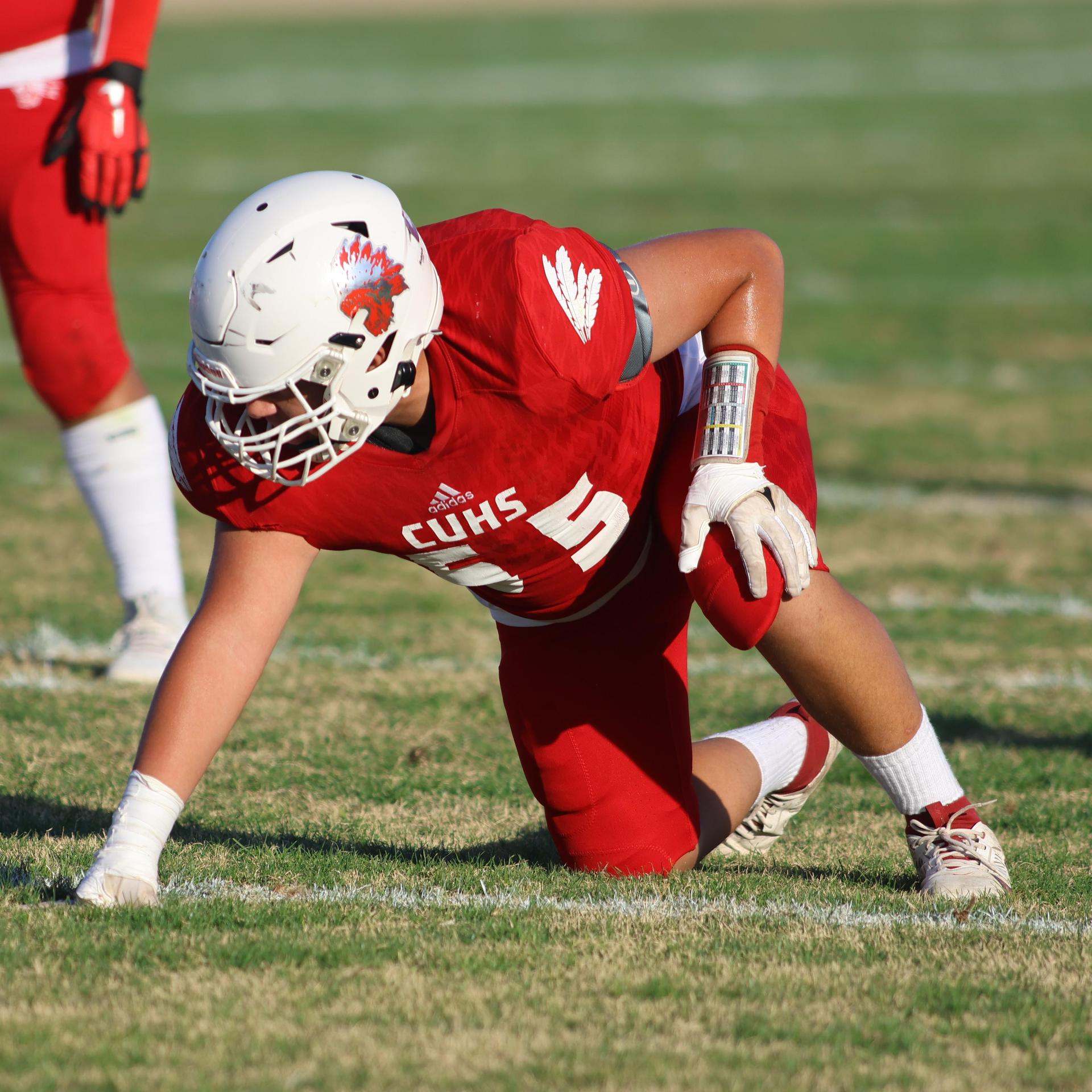 junior varsity football players in action against Fowler