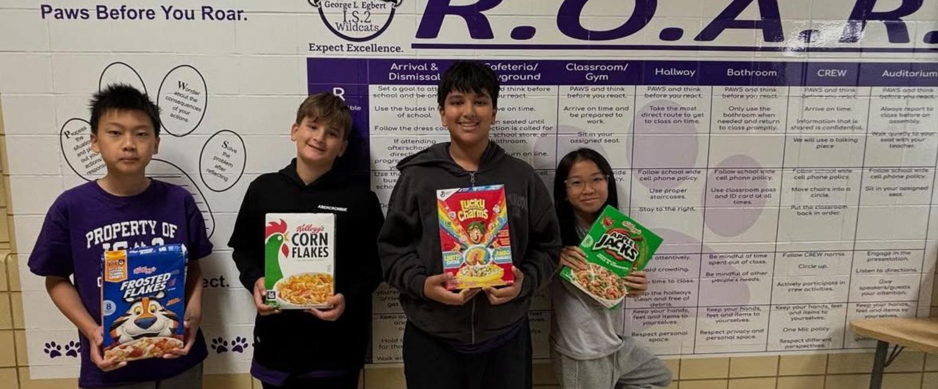 students holding boxes of cereal
