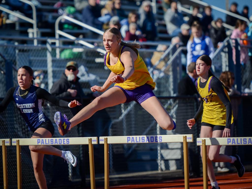 A track & field athlete jumping a hurdle.
