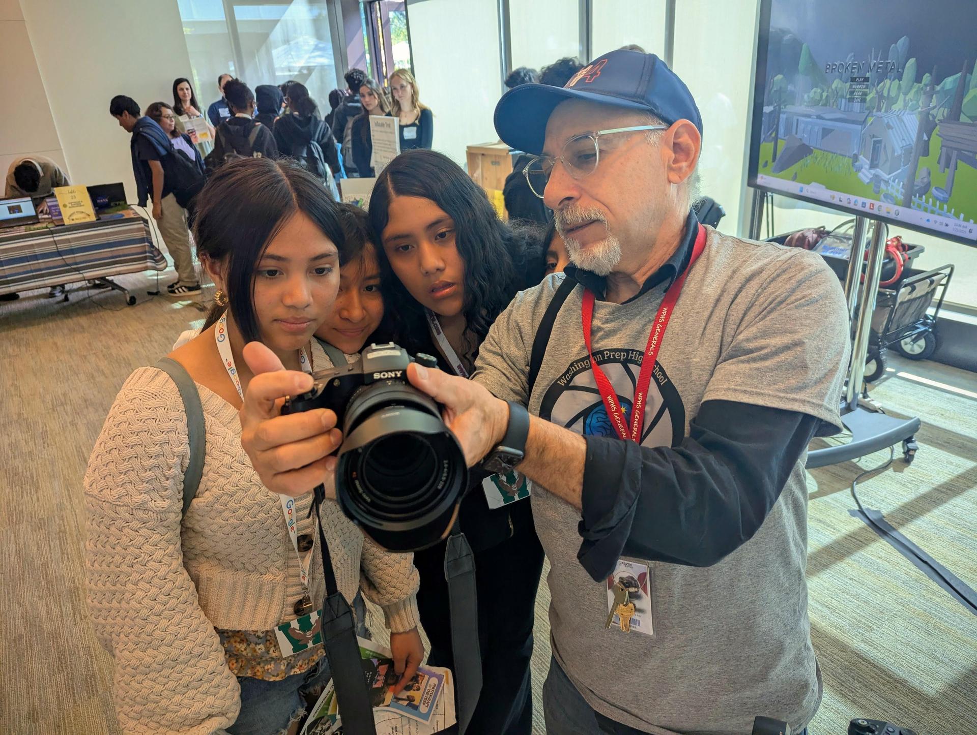 teacher showing camera to students