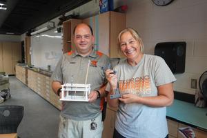 TKHS Cleaner Rob Rastoskey with art teacher Barb Maring and things he's made using his 3D printer.