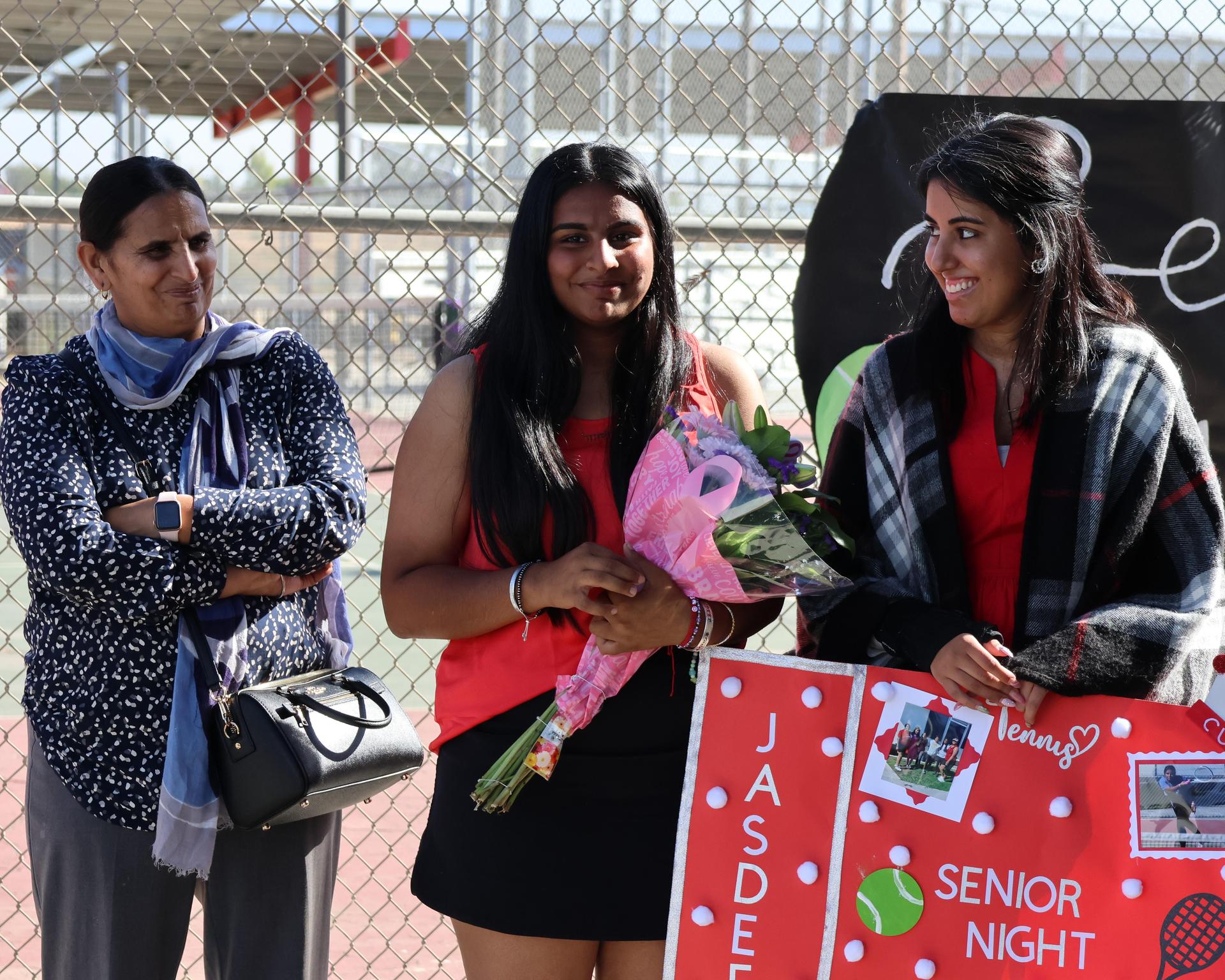 tennis players, family, and staff celebrating senior night