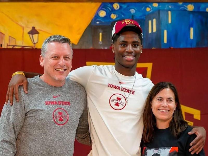 Three people smiling together, celebrating with Iowa State apparel in a vibrant setting.