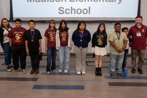 Madison group about 8 students and 2 teachers infront of projector