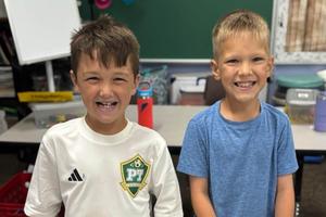 Dylan Bertosh and Hayden Harper pause from brainstorming their tower design for a photo