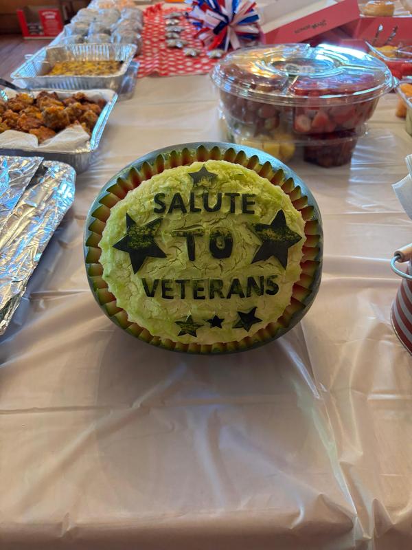 Watermelon carved with words " Salute to Veterans"