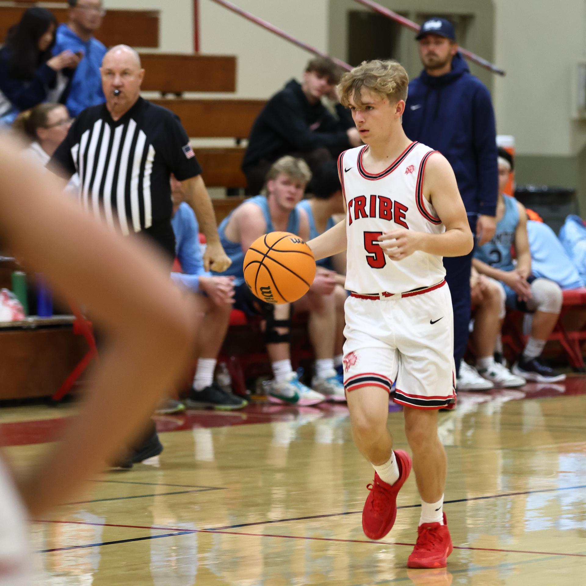 Varsity boys playing basketball against yosemite