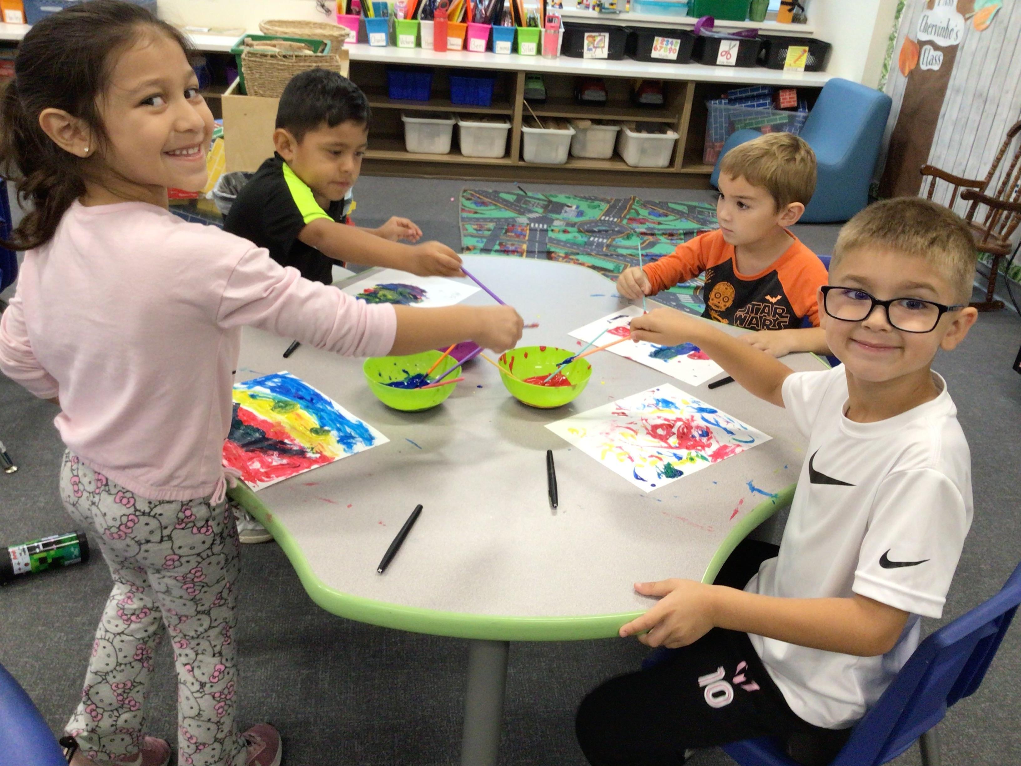 Photo of students around a table learning