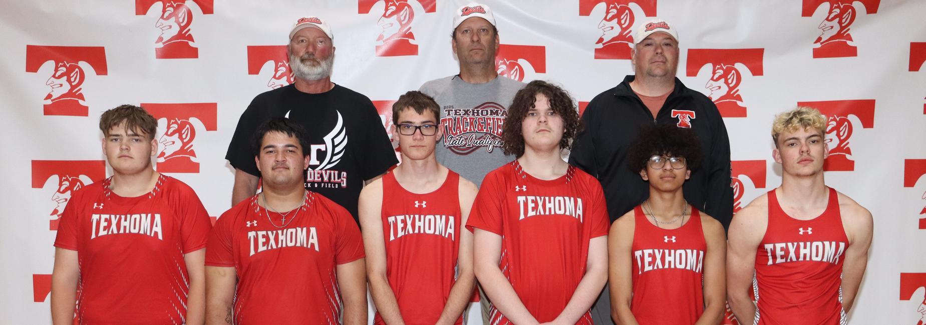 Group of young men in red athletic uniforms posing together.