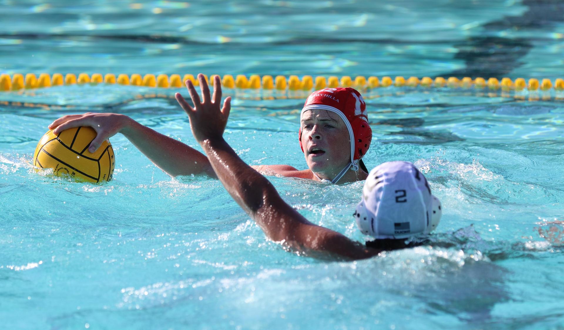 boys water polo players in action against hoover