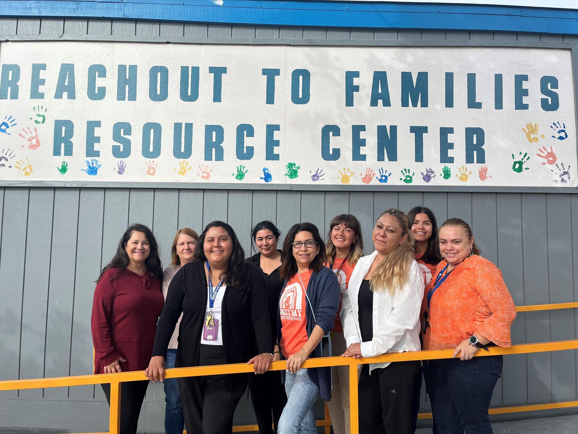 Educational Social Workers and Family Engagement and Support Liaisons in front of the Reach Out to Families Resource Center