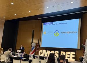 Speaker addresses participants at the 2026 National Civics Bee while Nashville School of Excellence is recognized as an event sponsor.