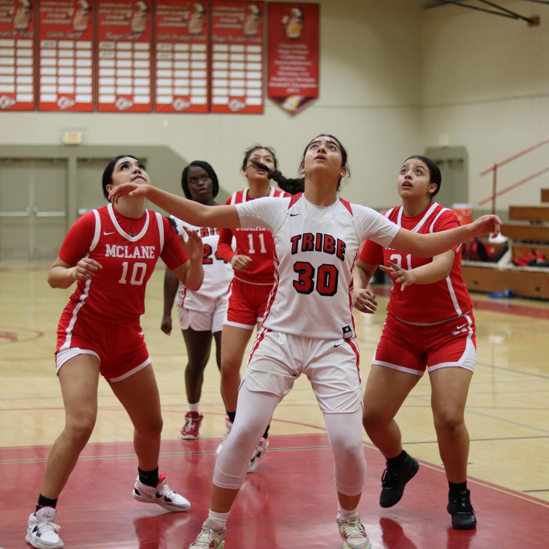 varsity girls playing basketball against mclane