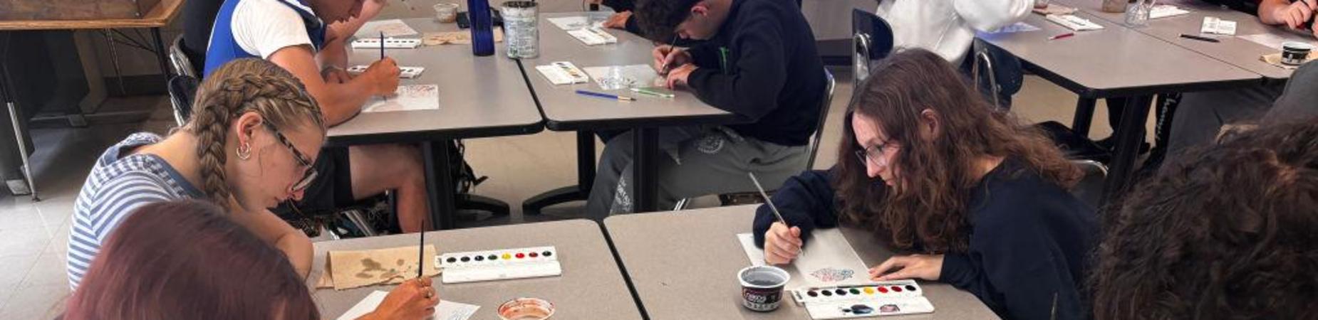 students painting in art class