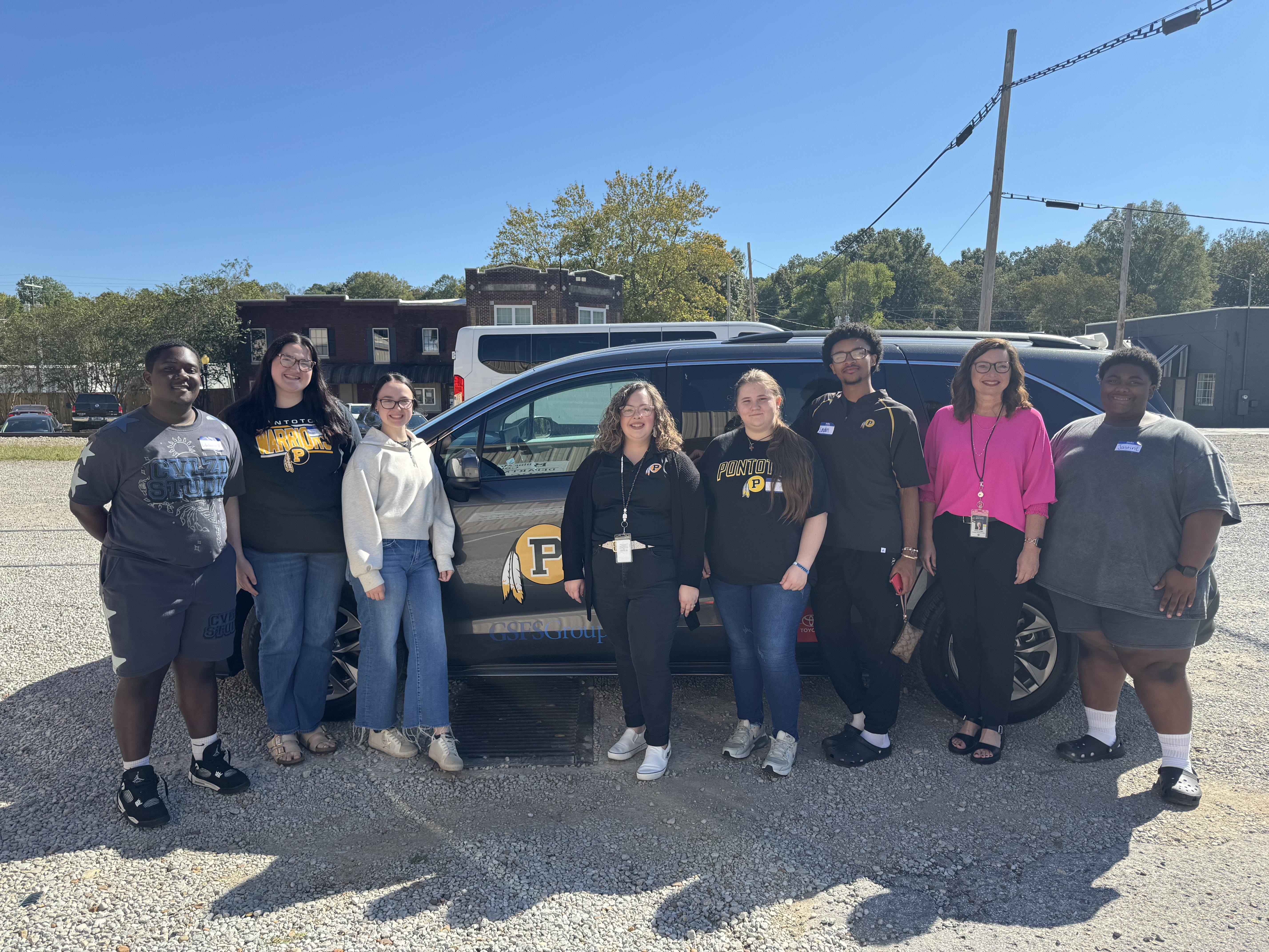 All PHS field trip attendees next to the new school van