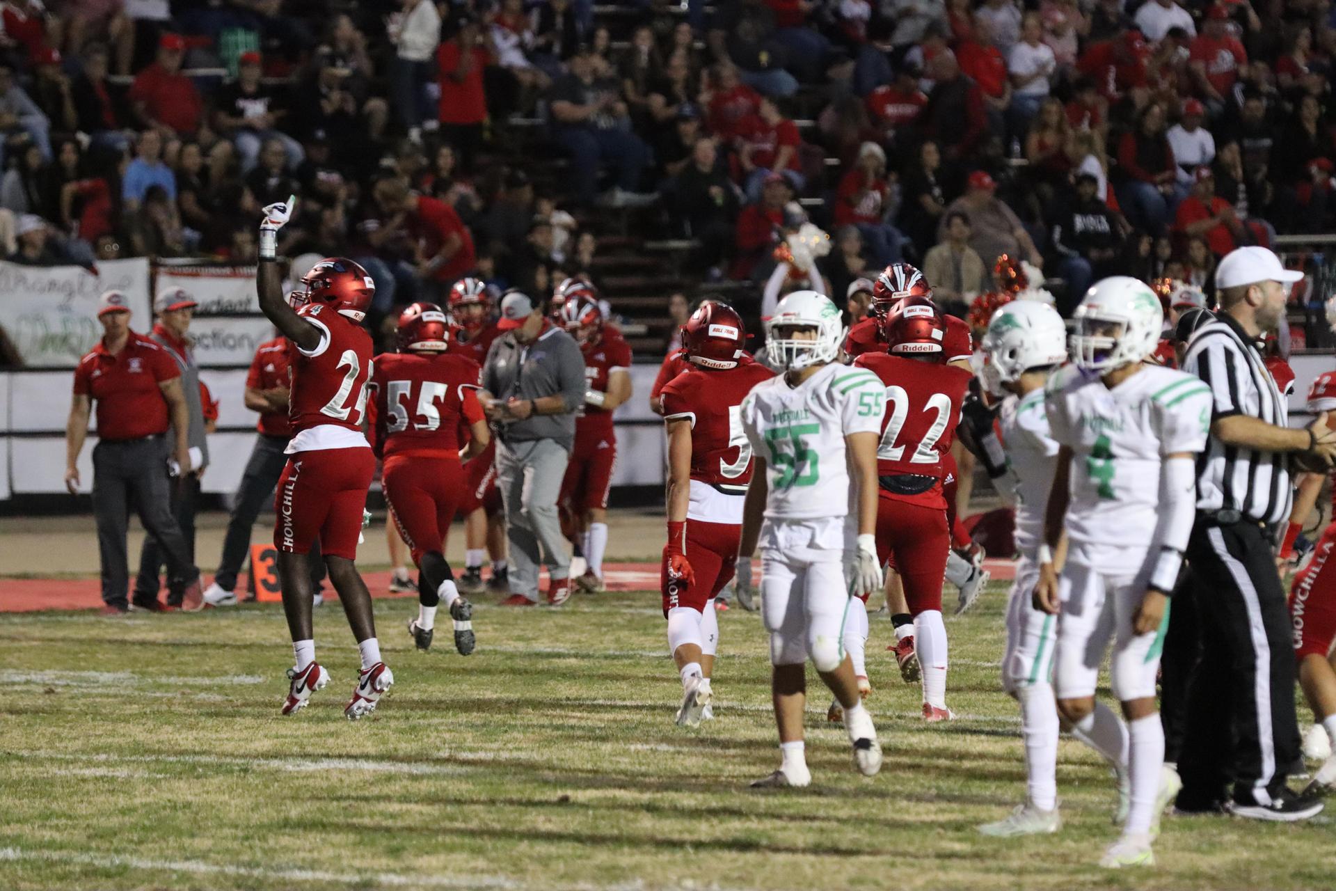 varsity football players in action against Riverdale
