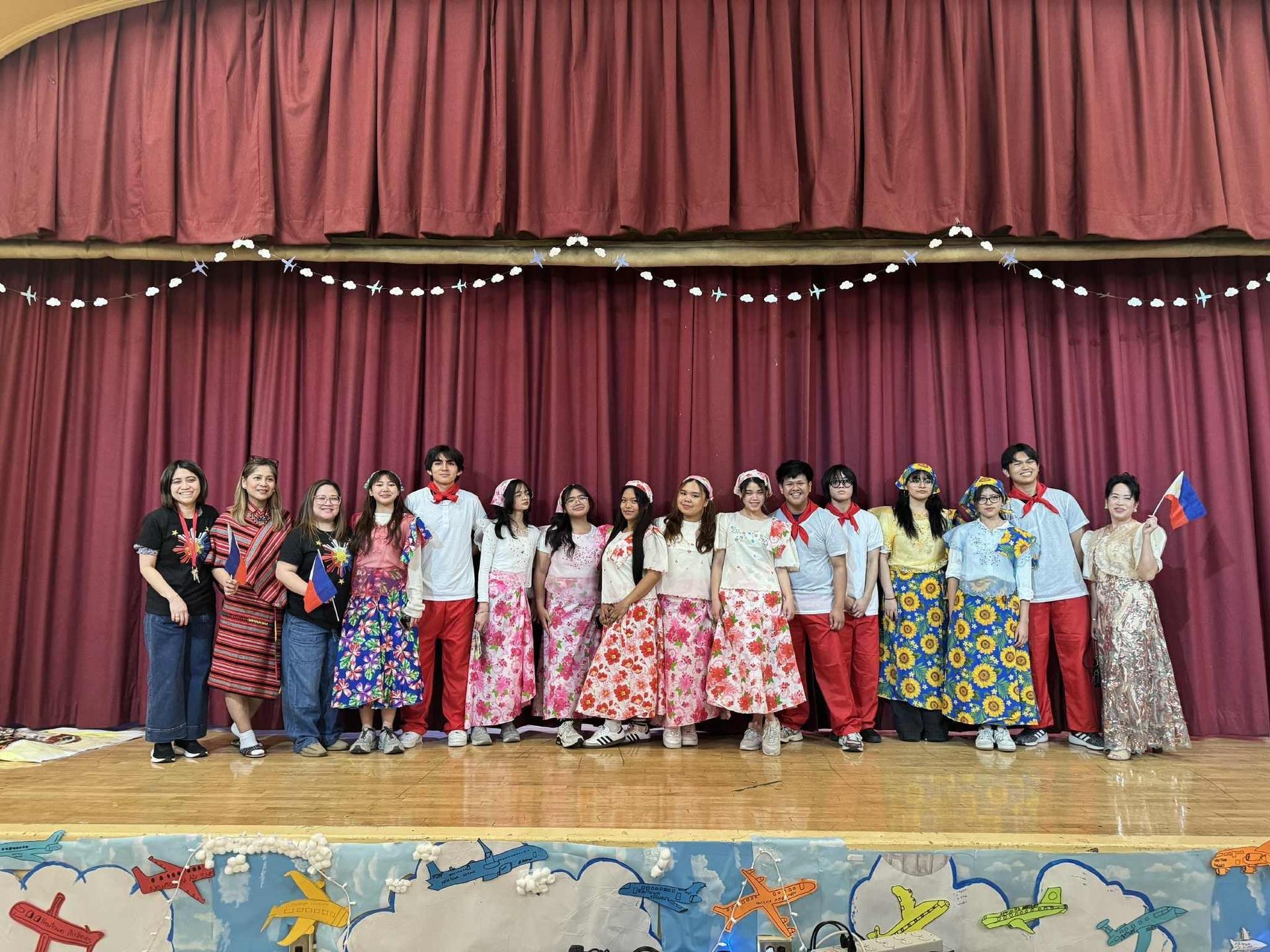 Students and teachers of the Filipino club on stage