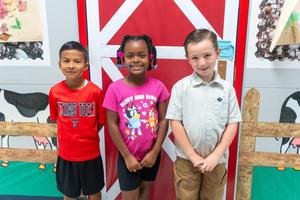 Westwind students posing in front of agriculture themed hallway.