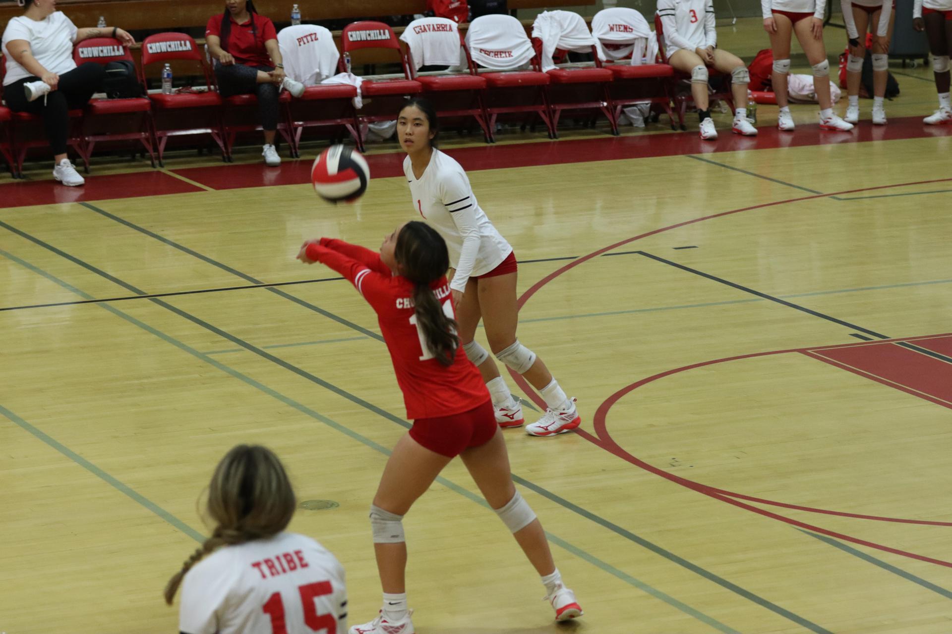 varsity volleyball players in action against liberty