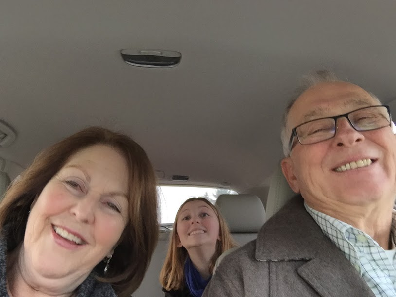 grandparents and granddaughter in car